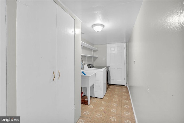 clothes washing area with light tile patterned floors and washing machine and clothes dryer