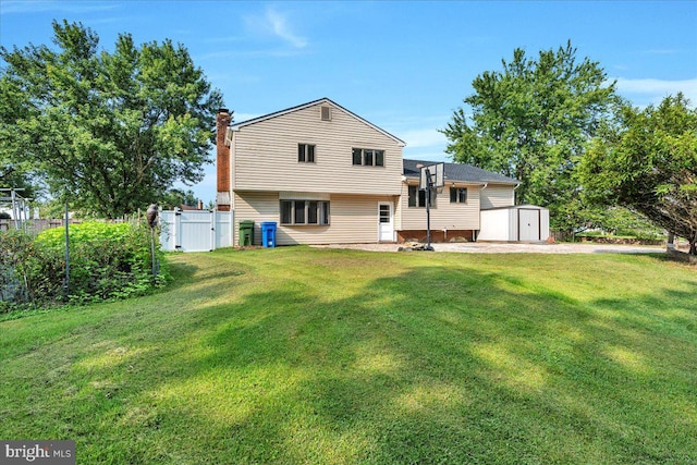 rear view of house featuring a shed and a yard