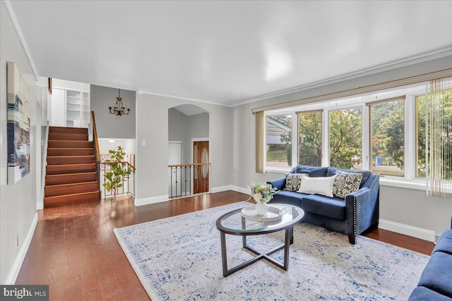 living room with ornamental molding, dark hardwood / wood-style floors, and a chandelier