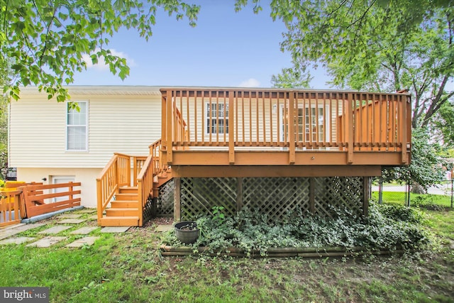 back of property with a wooden deck