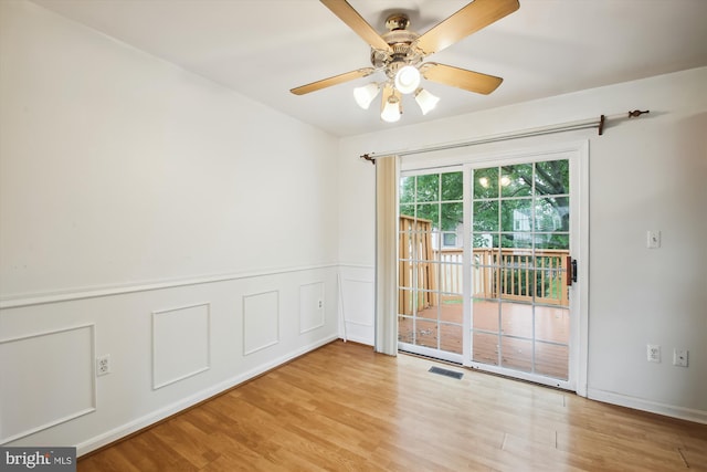 empty room featuring light hardwood / wood-style flooring and ceiling fan