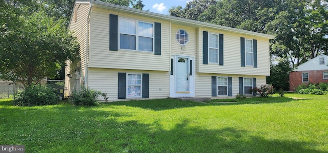 bi-level home with a front lawn