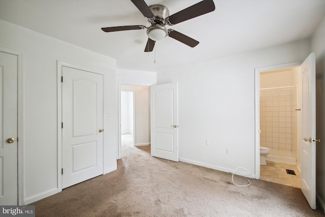 unfurnished bedroom with ensuite bathroom, ceiling fan, and carpet flooring