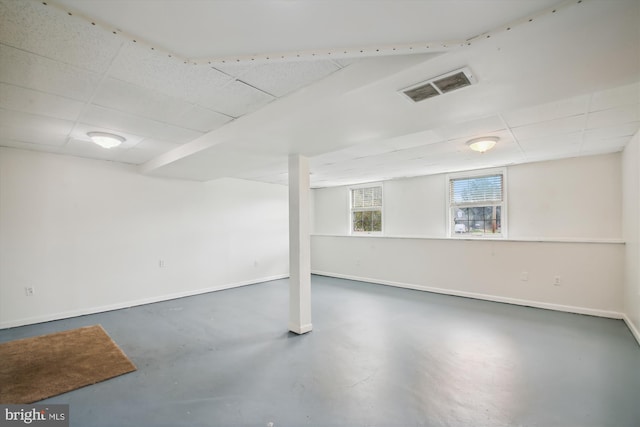 basement with a paneled ceiling