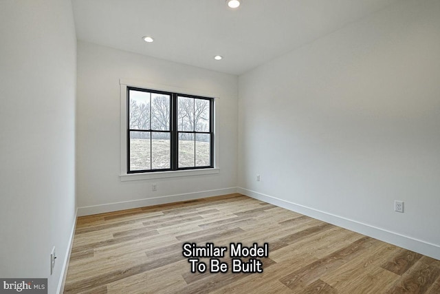 empty room with light hardwood / wood-style flooring