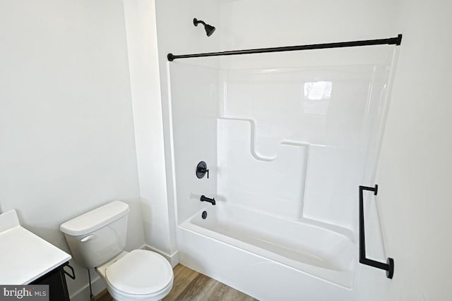 full bathroom with vanity, toilet, hardwood / wood-style floors, and shower / bath combination