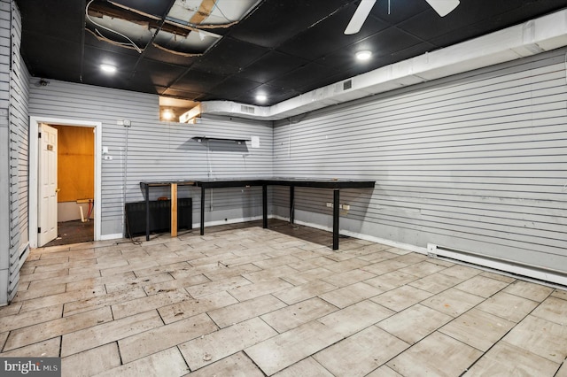 interior space with a baseboard radiator and ceiling fan