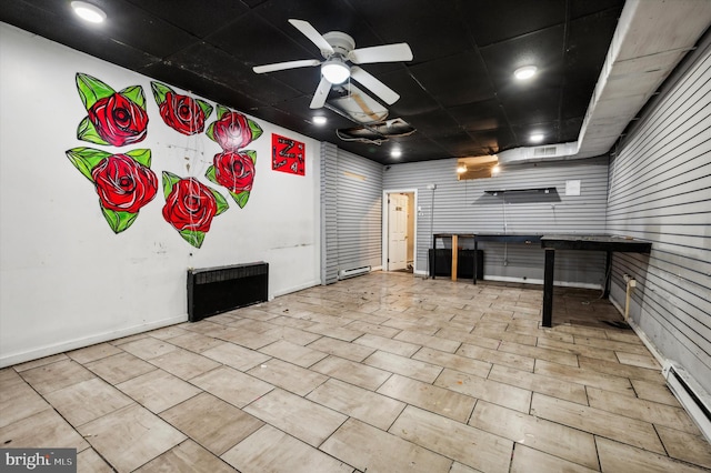 unfurnished living room featuring light tile patterned floors, a baseboard heating unit, and ceiling fan