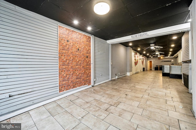 interior space with ceiling fan