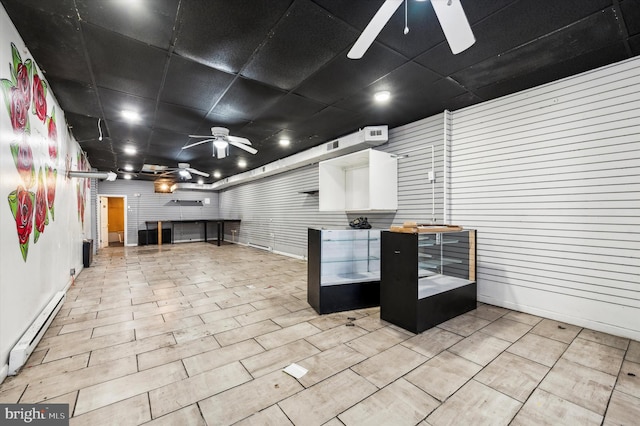 interior space featuring baseboard heating and ceiling fan