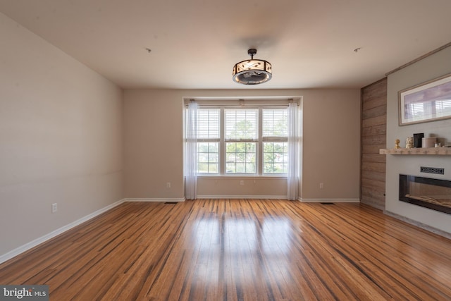 unfurnished living room featuring hardwood / wood-style flooring