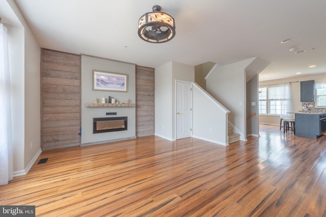 unfurnished living room featuring hardwood / wood-style flooring