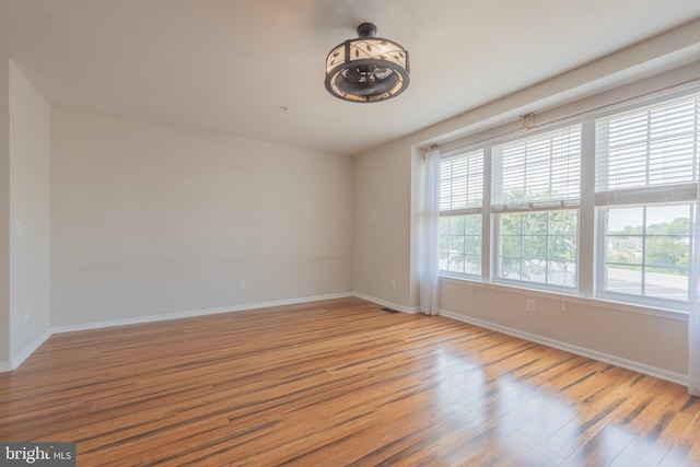 unfurnished room with hardwood / wood-style floors