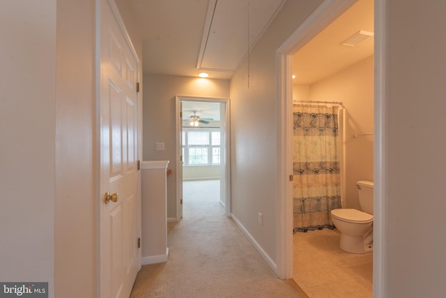 hallway with light colored carpet