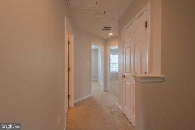 hall featuring light colored carpet