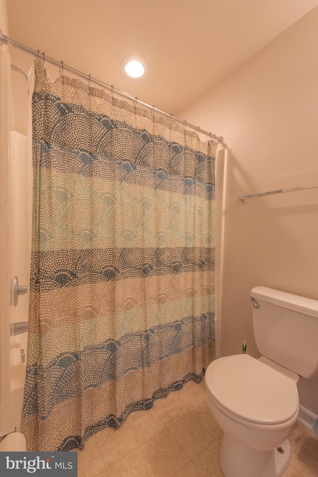 bathroom featuring toilet and tile patterned flooring