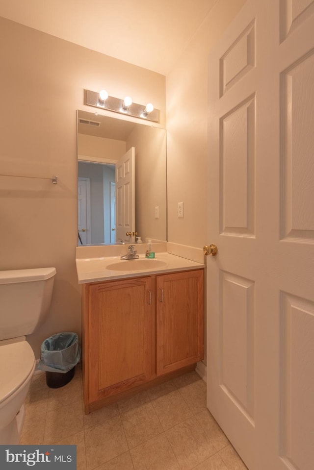 bathroom with tile patterned flooring, toilet, and vanity