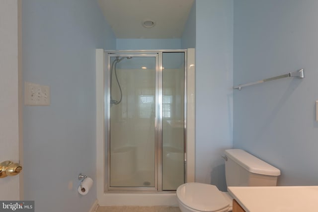 bathroom with an enclosed shower, toilet, and vanity