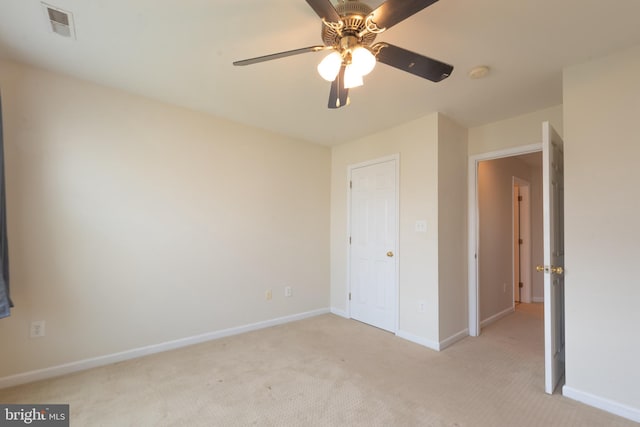 unfurnished bedroom with ceiling fan and light carpet