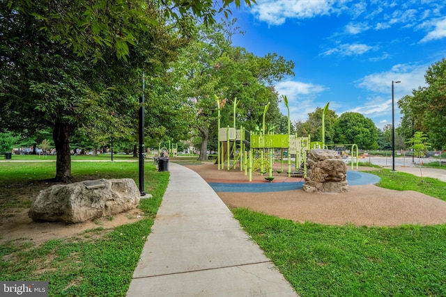 surrounding community featuring a playground and a lawn