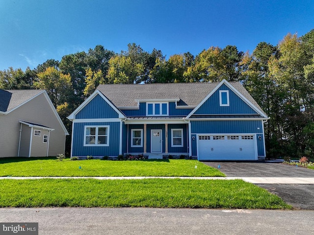 14274 Schooner Run Unit 83, Ellendale, DE 19941 - view of front of property featuring a front yard, asphalt driveway, an attached garage, a standing seam roof, and board and batten siding