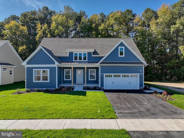 14274 Schooner Run Unit 83, Ellendale, DE 19941 - view of front of property with a standing seam roof, a porch, driveway, metal roof, and a front lawn