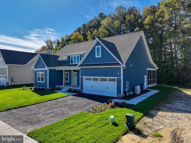 14274 Schooner Run Unit 83, Ellendale, DE 19941 - traditional-style house with a standing seam roof, board and batten siding, central air condition unit, driveway, and metal roof