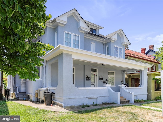 view of front of property featuring covered porch and a front yard