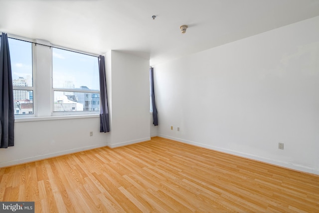 spare room featuring light hardwood / wood-style floors