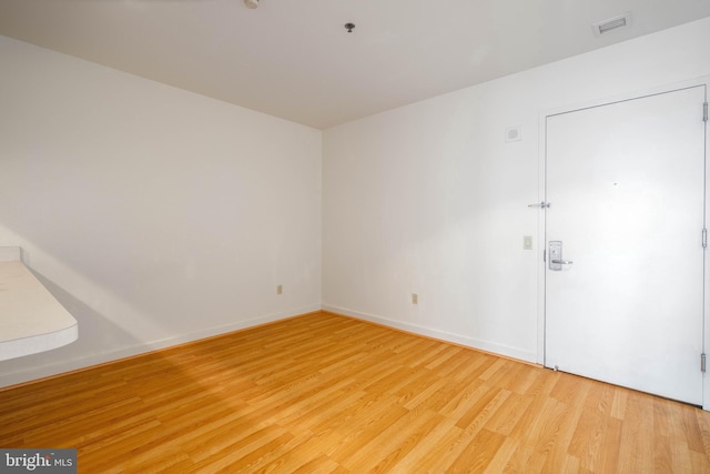 unfurnished room with light hardwood / wood-style flooring