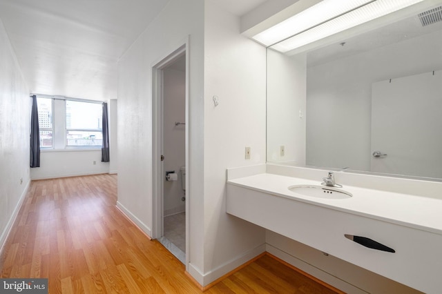 bathroom featuring sink and hardwood / wood-style floors