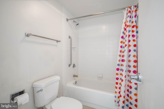 bathroom featuring shower / bath combo and toilet