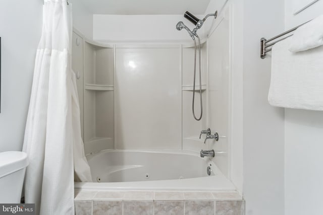 bathroom featuring shower / bathtub combination with curtain and toilet