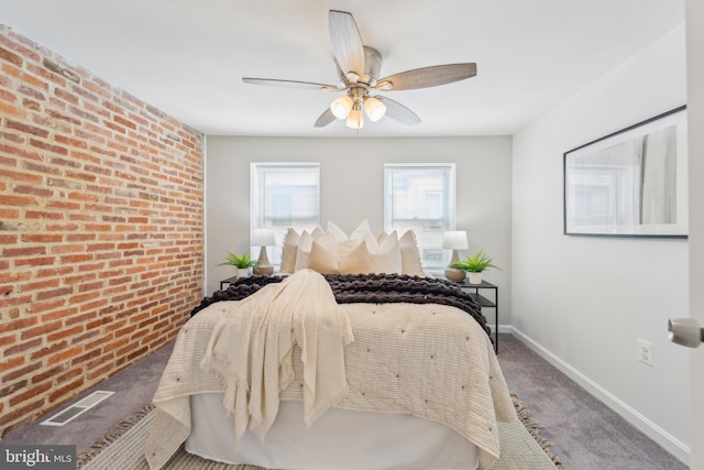 carpeted bedroom with brick wall and ceiling fan