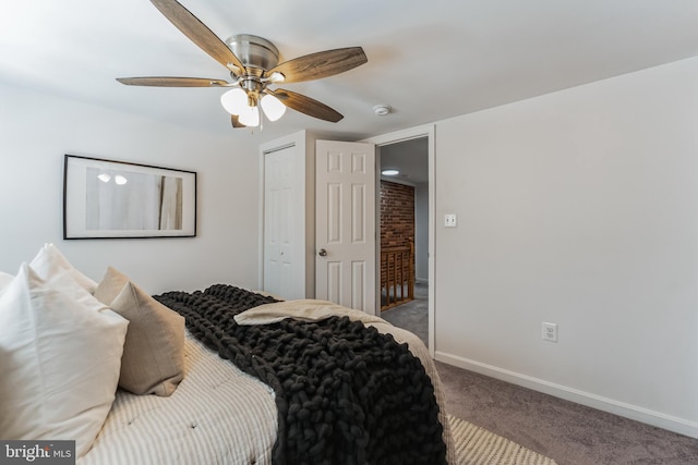 carpeted bedroom featuring ceiling fan and brick wall