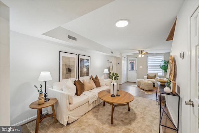 living room featuring ceiling fan and light hardwood / wood-style flooring