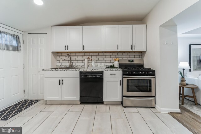 kitchen featuring dishwasher, gas range, sink, vaulted ceiling, and white cabinets