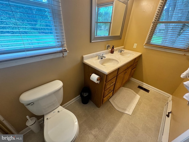 bathroom featuring vanity, tile patterned flooring, and toilet