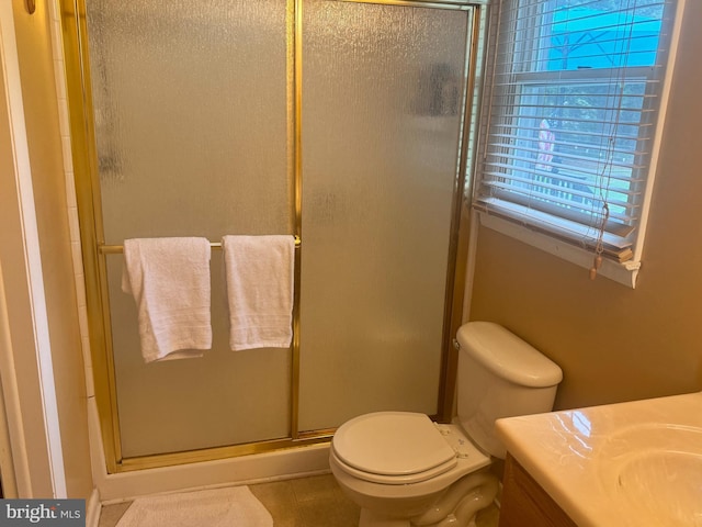 bathroom with an enclosed shower, tile patterned floors, vanity, and toilet