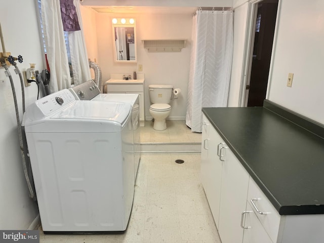 interior space with vanity, toilet, tile patterned flooring, and separate washer and dryer