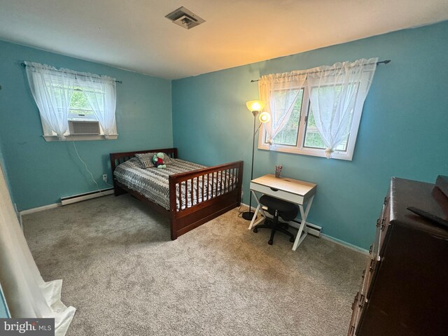 carpeted bedroom with multiple windows and a baseboard radiator