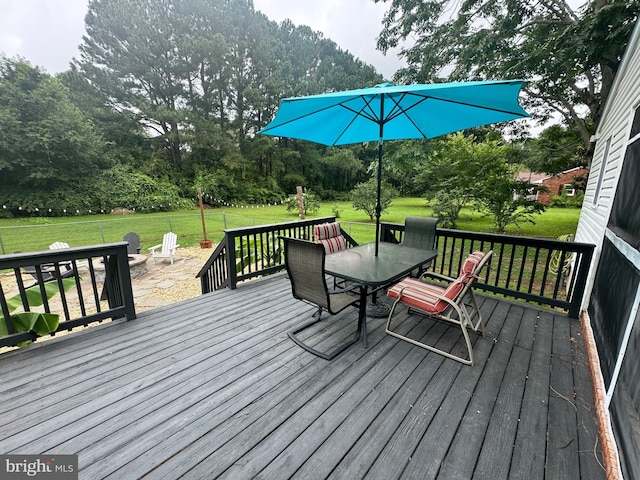 back of house featuring a deck and a fire pit