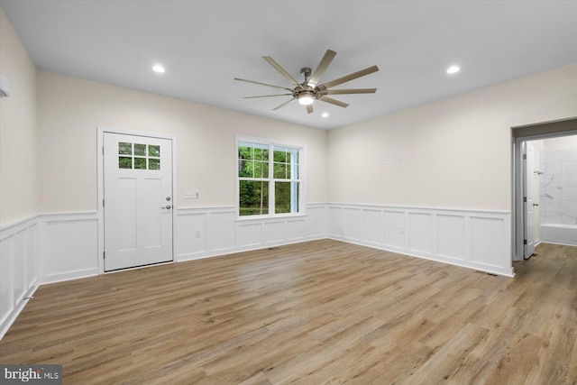 foyer entrance featuring wainscoting, light wood-style flooring, a ceiling fan, and recessed lighting