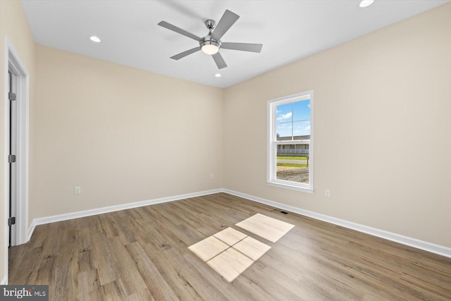 spare room featuring light wood-type flooring and ceiling fan