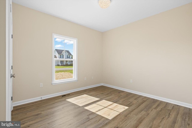 unfurnished room featuring wood-type flooring