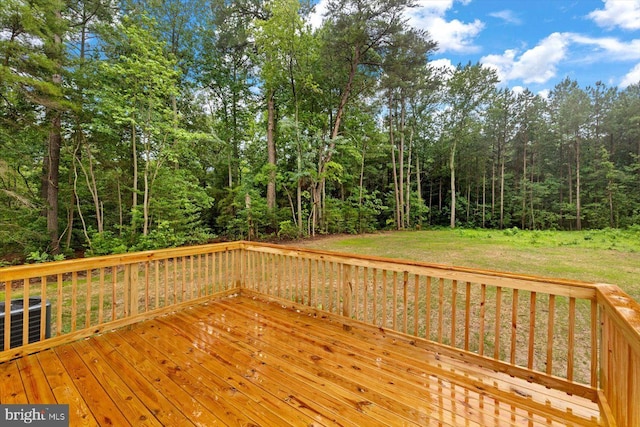 wooden terrace featuring central AC unit and a yard