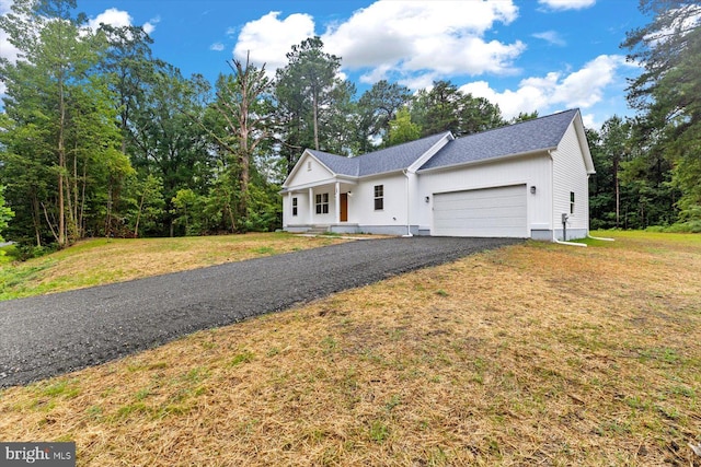 view of front of house featuring a garage and a front lawn