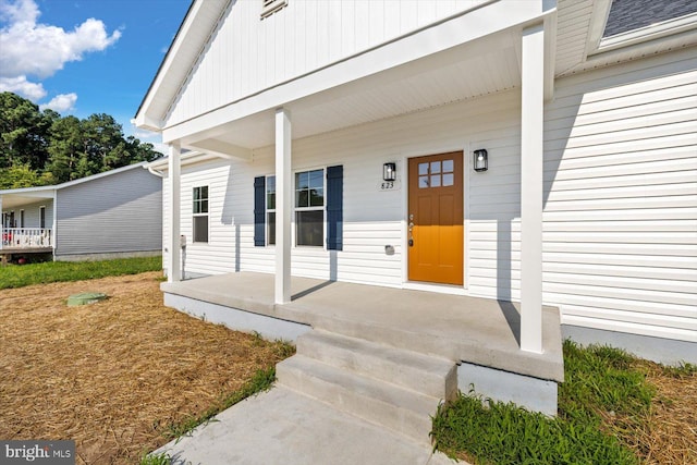 property entrance featuring a porch