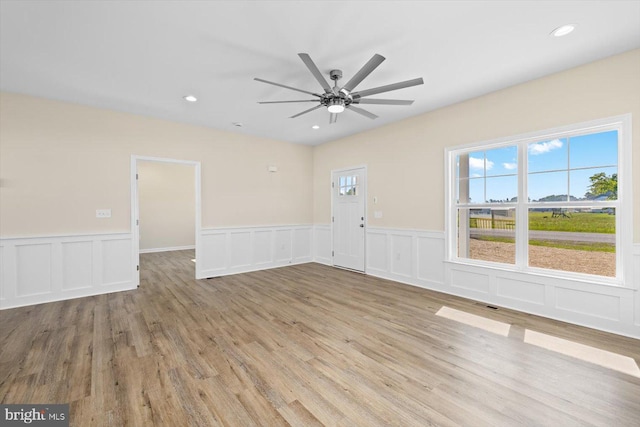 unfurnished room featuring ceiling fan and light hardwood / wood-style floors