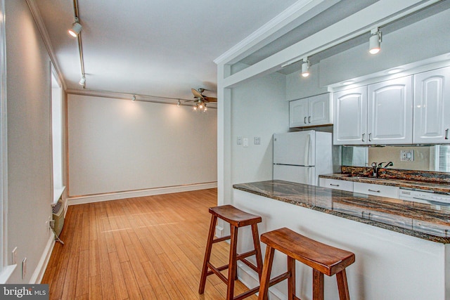 kitchen with ceiling fan, rail lighting, white cabinets, white appliances, and ornamental molding